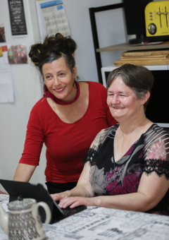 2 women in front of computer